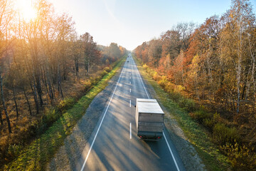 Aerial view of cargo truck driving on highway hauling goods. Delivery transportation and logistics...