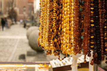 Colorful showcases of traditional jewelry stores and amber gemstone products in city market square...