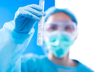 Lab assistant uniform with mask gloves holding test tube with science laboratory research sample while analyzing development on biology chemical as graph growth increase investment revenue, copy space