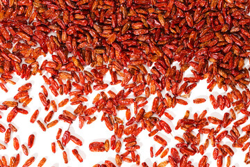 Dried Barberry berries as top view textured background on white fon. Ripe dry sour-tasting berries, healthy seasoning for food. Red Barberry food, medicinal plant. Healthy and tasty spice