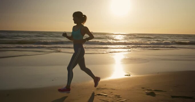 sport woman running on beach