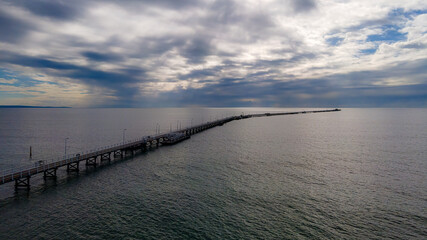 Fototapeta na wymiar Aerial view of Busselton Jetty the longest timber-piled jetty in the southern hemisphere at 1,841 metres long.