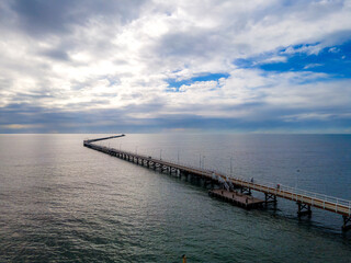 Fototapeta premium Aerial view of Busselton Jetty the longest timber-piled jetty in the southern hemisphere at 1,841 metres long.
