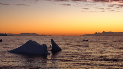 Sunset silhouetting icebergs at Cierva Cove, Antarctica