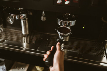 barista use coffee machine with bottomless filter. coffee maker concept.