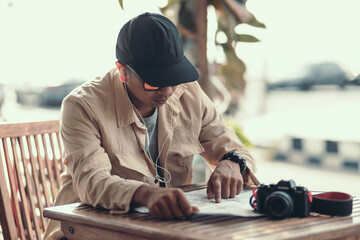 Tourists point their fingers at the map to find attractions, restaurants or hotels..backpacker and...