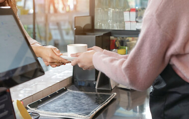 waitress serving hot coffee to customer