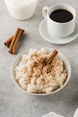  Scandinavian rice porridge in a bowl with cinnamon. Healthy breakfast.
