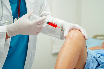 Asian doctor inject Hyaluronic acid platelet rich plasma into the knee of senior woman to walk...