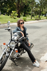 Fototapeta na wymiar Mature Woman Leaning on Motorcycle