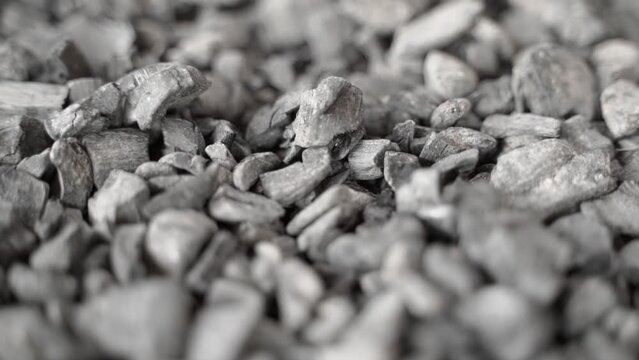 Fossil coal close-up, reserves. Smooth motion close-up over near hard coal in a warehouse. Raw materials for heating and electricity production. Unlimited use of the planet's resources