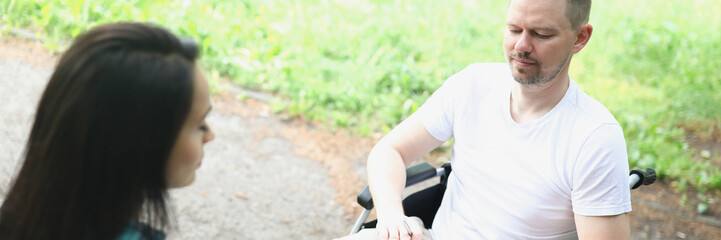 A man in a wheelchair in makes notes