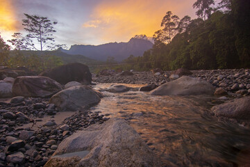 Fototapeta na wymiar Sunrise view of a river with majestic Mount Kinabalu at background.