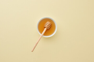 Top View of sweet honey on pastel yellow background