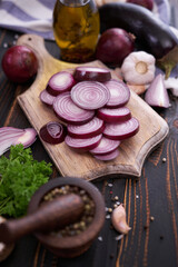 Red Onion on wooden cutting board with dark background