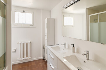 Fototapeta na wymiar Interior of a modern bathroom in light tones with shower reflected in a big mirror