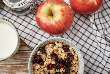 Granola with milk in blue bowl on wooden table, Healthy organic breakfast with muesli, Food clean eating concept, top view
