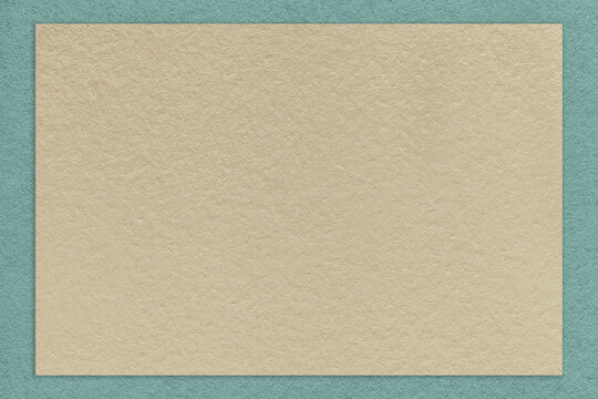 Texture of old craft beige color paper background with blue border. Vintage kraft cerulean and brown cardboard