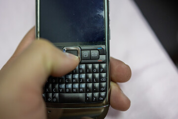 Man hand holding a Year 2008 mobile phone