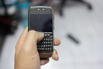 Man hand holding a Year 2008 mobile phone