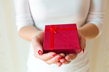 Gift box in woman hands.