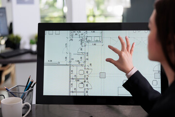 Real estate studio employee working in room floor planner software, zooming in apartment plan with touchscreen. Cad blueprints on computer monitor screen, designer drafting architectural sketch. - obrazy, fototapety, plakaty