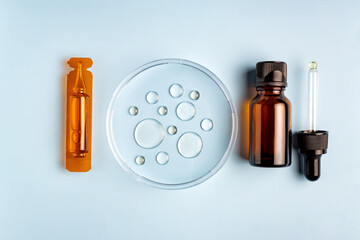 plastic ampoule, dropper bottle and petri dish with drops of oil. Cosmetic laboratory research. Concept beauty hair, Self-care and wellness.
