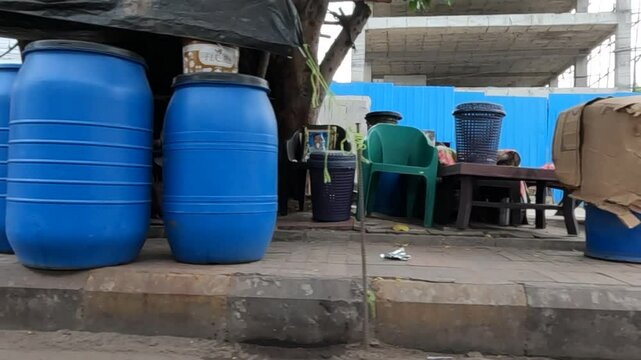 Shot of plastic containers and chairs under the tree
