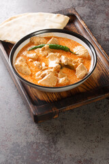 Kukul Mas Maluwa Sri Lankan Chicken Curry closeup in the bowl on the table. Vertical