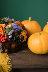 Autumn pumpkins and flowers on a wooden table