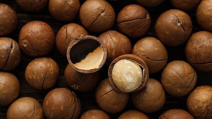 Macadamia nut. Open nut and shell on a background from whole nuts top view