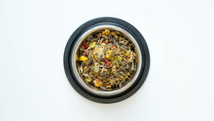 Rodent food from cereals and seeds in a metal round bowl on a white background