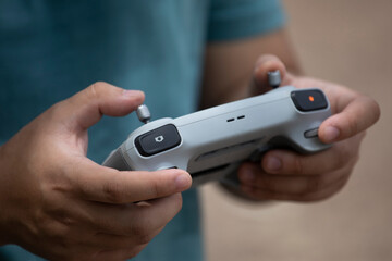 Close up of Young man's hands on remote controller while flying a drone.