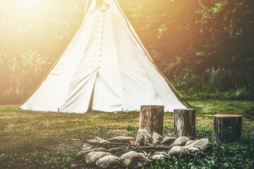 white teepee indian tent standing in beautiful landscape.