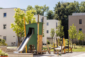 Kids Playground Slide Residential buildings. Modern Playground for Childrens in Public Housing block. Modern Wooden Playground Landscape Yard. 