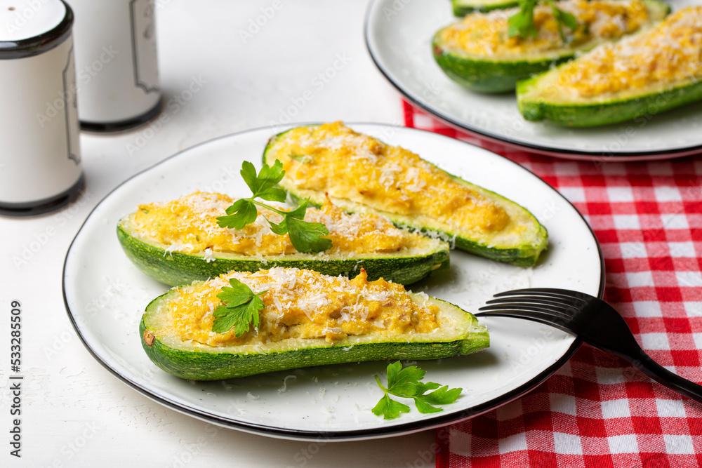 Poster Baked Zucchini boats stuffed with ricotta cheese and tuna fish, parmesan cheese. Close-up.