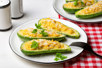 Baked Zucchini boats stuffed with ricotta cheese and tuna fish, parmesan cheese. Close-up.