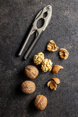 Fototapeta na wymiar Peeled walnut on dark table.