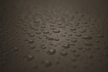 Close up of dropped water on a brown background. Freshness, raindrop