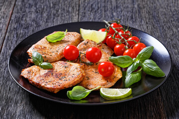 tomato basil pesto fried pork cutlets on plate