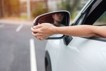 woman driver adjusting side view mirror a car. Journey, trip and safety Transportation concepts - Powered by Adobe