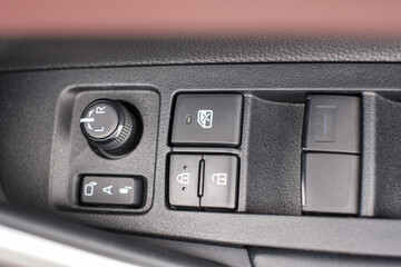 buttons controlling the windows inside a car, control and electric mirror adjustment
