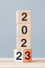 2022 chang to 2023 wooden cube blocks on table background. Resolution, plan, review, goal, start, end year  and New Year holiday concepts