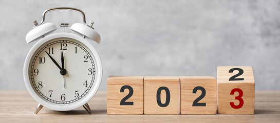 Happy New Year with vintage alarm clock and flipping 2022 change to 2023 block. Christmas, New...
