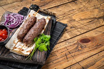 Traditional middle east kefta, kofta kebab from ground beef and lamb meat grilled on skewers served...