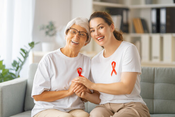Smiling women with red satin ribbon