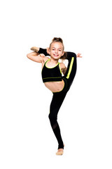 Gymnastic tricks. A flexible little girl gymnast in a sports black suit keeps her balance while...
