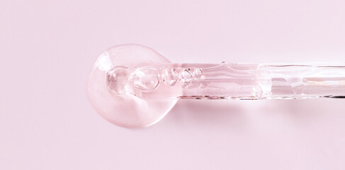 banner glass pipette serum closeup on a light pink background