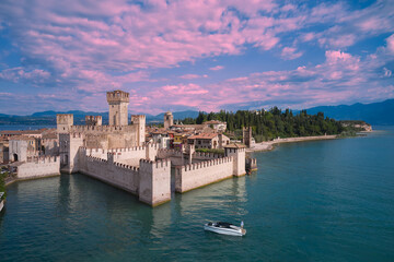 Pink clouds over Scaligero Castle aerial view. Scaligero Castle at sunrise, Lake Garda, Italy. Scaligero Castle aerial view.