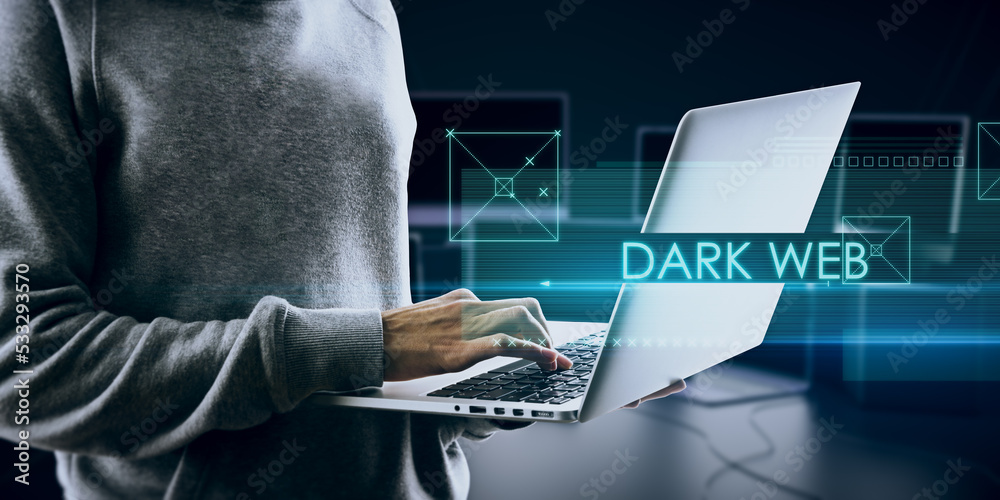 Fototapete Abstract dark web text over hacker holding and using notebook computer on blurry background. Hacking and attack concept. Double exposure.